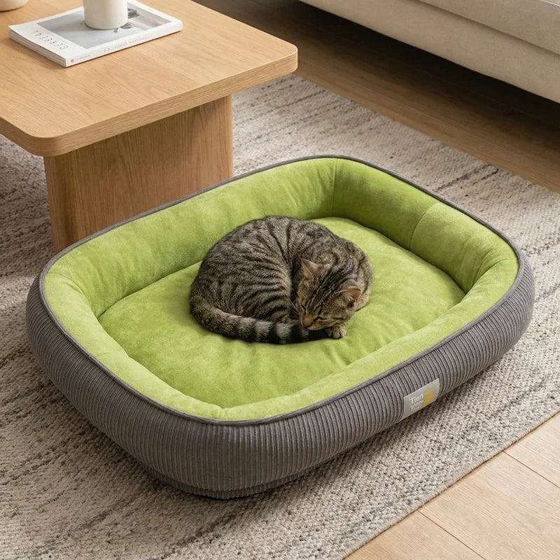 Rectangular grey corduroy pet bed with a lime green plush interior holding a curled tabby cat.