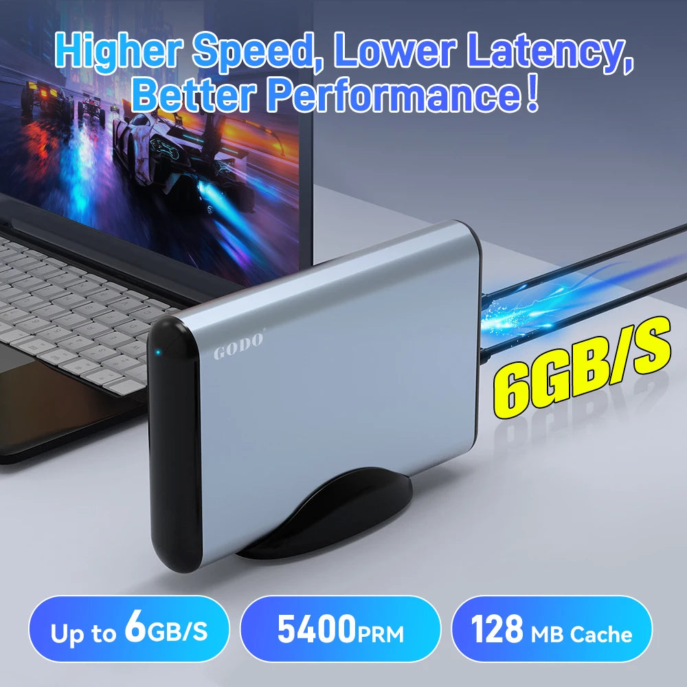 Silver and black rectangular external gaming HDD in a stand, connected to a laptop.