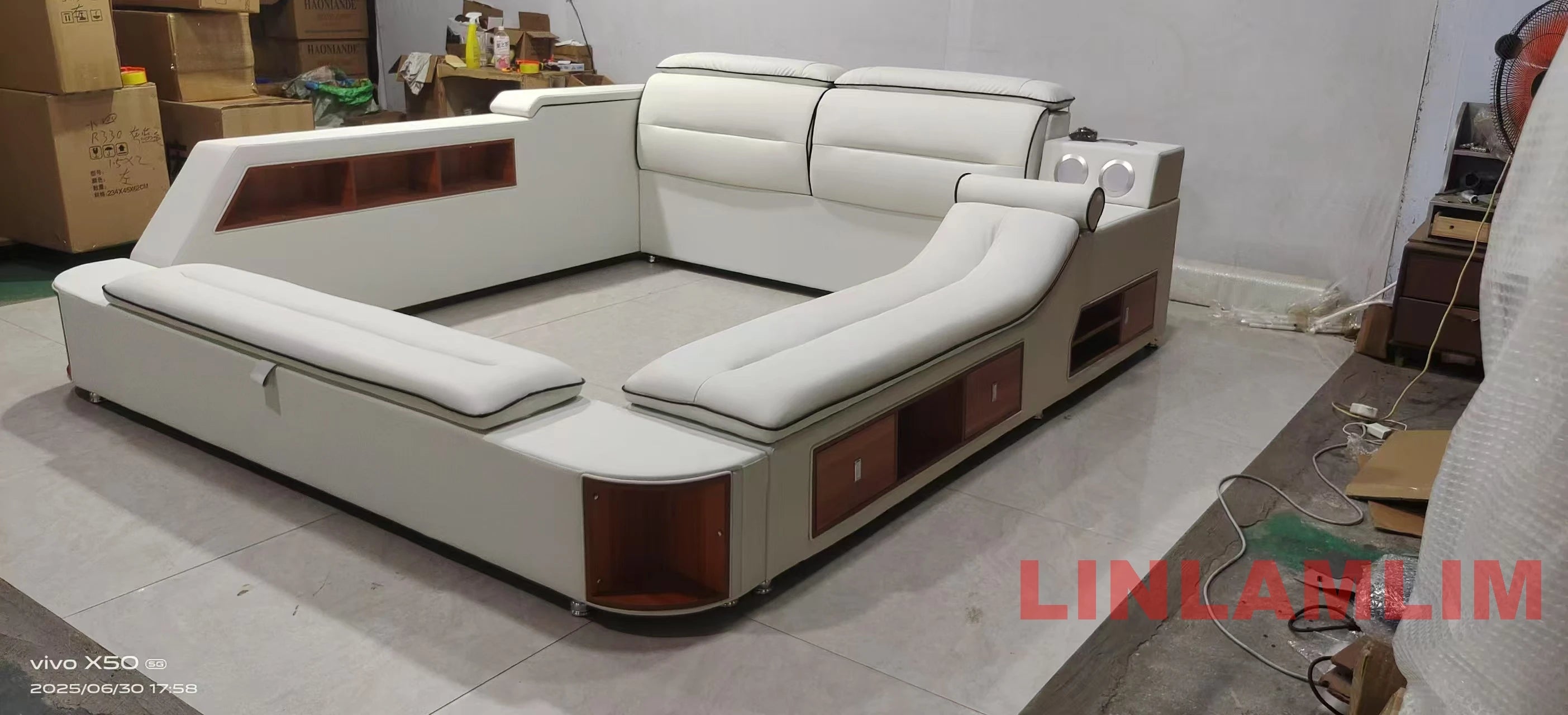 Modern white genuine leather platform bed with built-in storage shelves, integrated side tables, and LED light features.