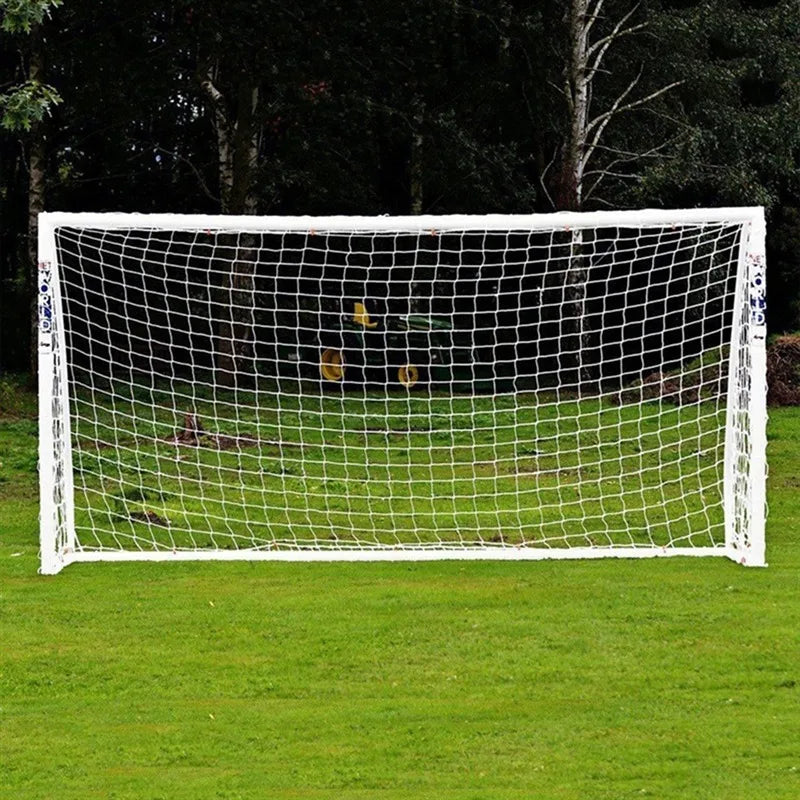 White freestanding football goal with durable mesh netting, set up on a grass field.
