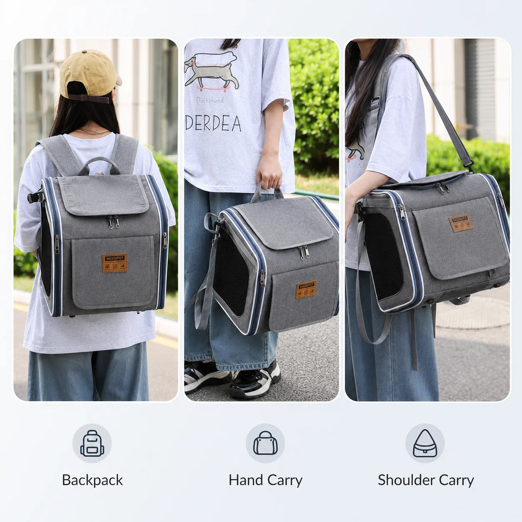 Grey pet carrier backpack with black mesh sides, front pocket, top handle, and adjustable straps shown worn.