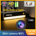 Black and white plastic LED light with integrated 1080p Wi-Fi mini security camera and 128GB storage card slot.