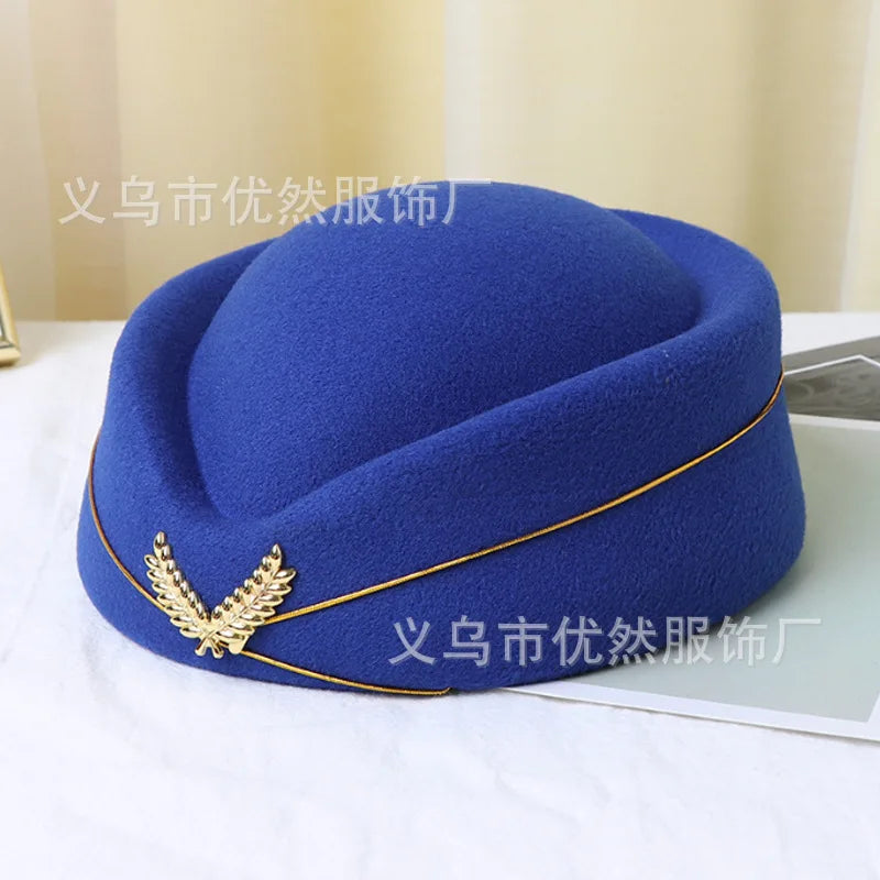Blue vintage-style felt pillbox stewardess hat, featuring a gold trim and a metallic laurel leaf emblem.