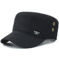 Black cotton military-style cadet cap with a flat top, stiff peak, side eyelets, and a small silver eagle emblem.