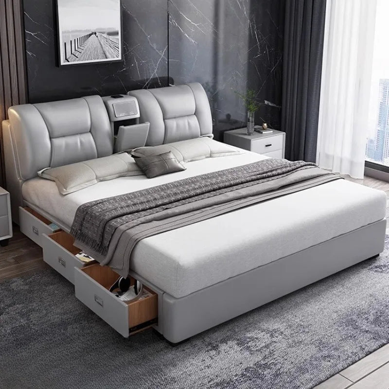 Modern grey upholstered king-size bed frame with integrated storage drawers and a built-in headboard shelf.