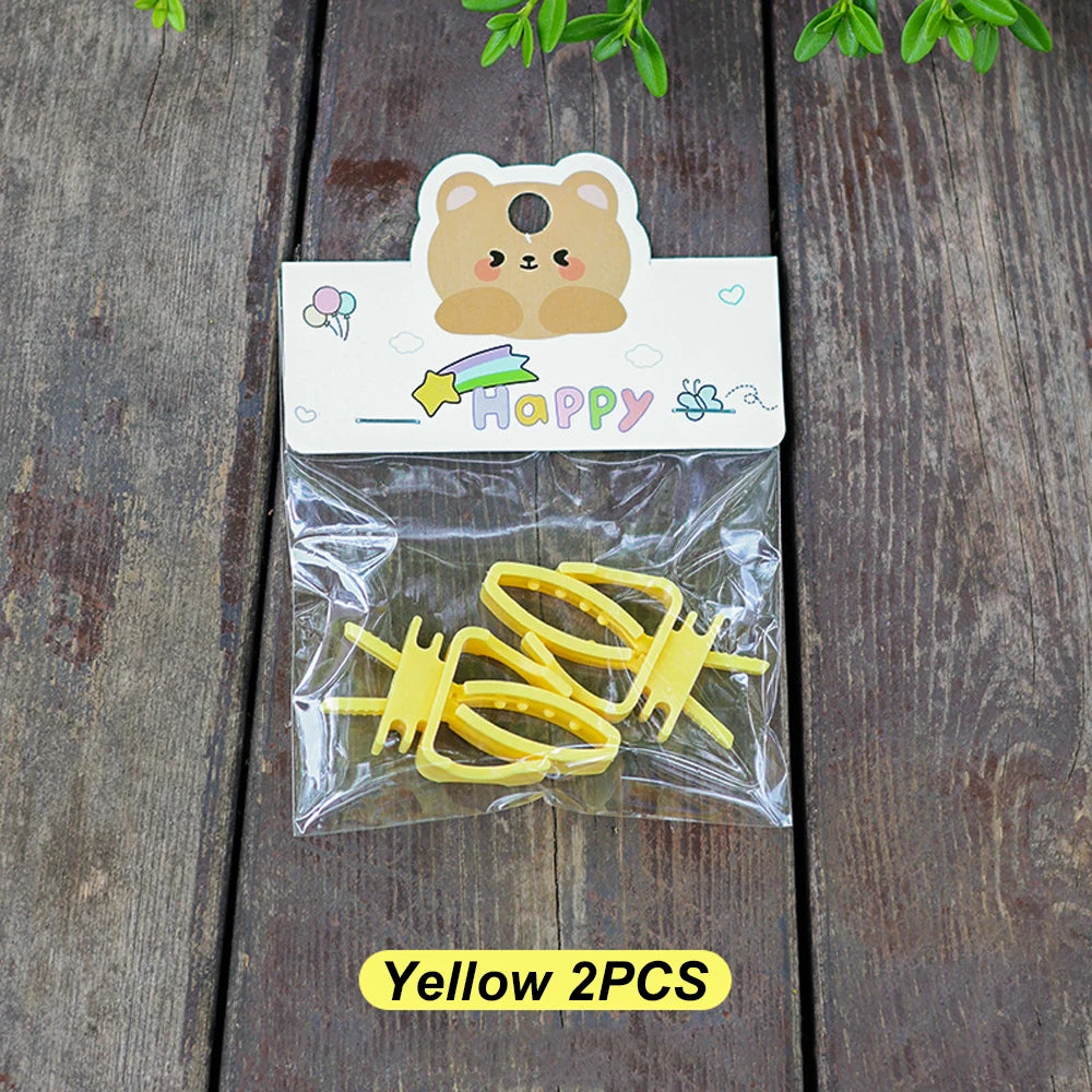 Two yellow plastic hair clips in clear packaging with a cute bear-themed "Happy" header card.
