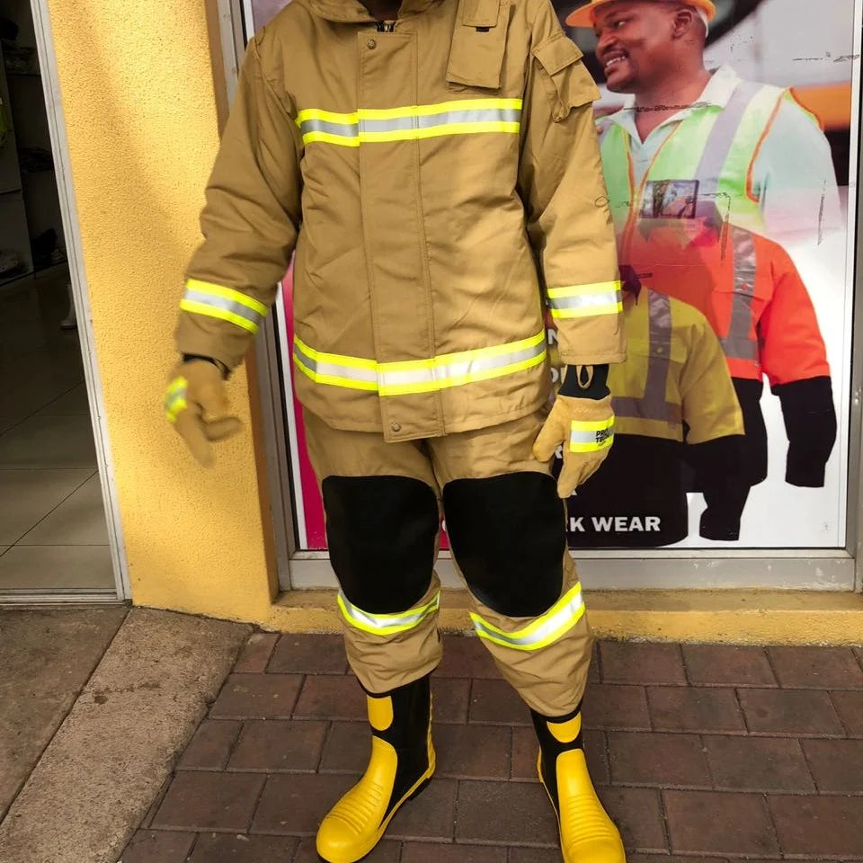 Tan firefighter turnout gear with reflective strips, black knee patches, matching gloves, and black and yellow boots.