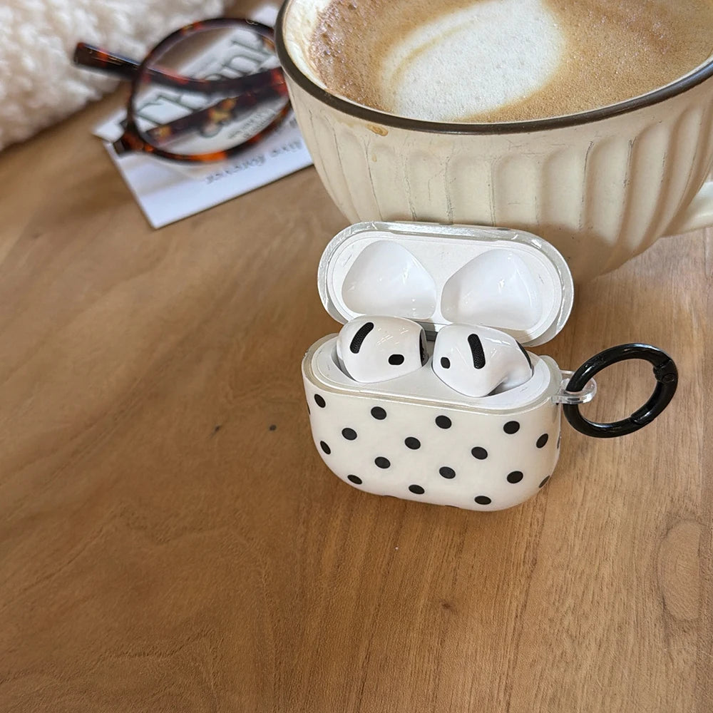 Clear AirPods case with black polka dots, featuring a black carabiner clip, suitable for standard AirPods.