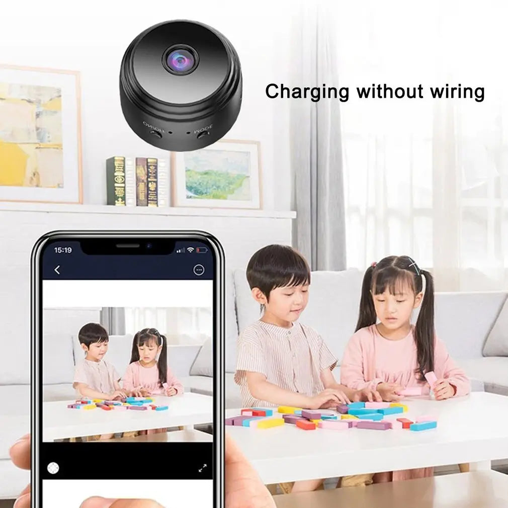 Black, circular, wireless plastic security camera shown with a mobile app interface streaming video of two children.