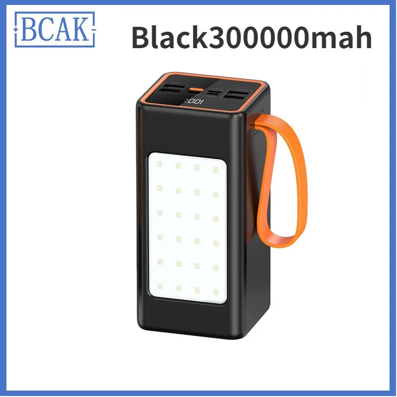 Black portable power bank with orange strap, multi-port top, integrated LED light panel and digital battery display.
