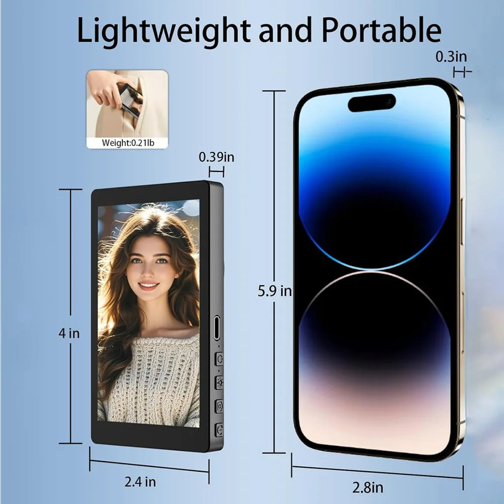 Black portable media player with a touchscreen display, shown next to a smartphone for size comparison.