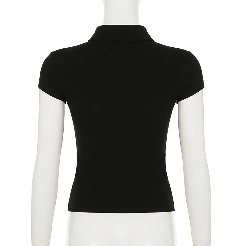 Back view of a plain black fitted polo shirt with short sleeves and a classic collar on a mannequin.