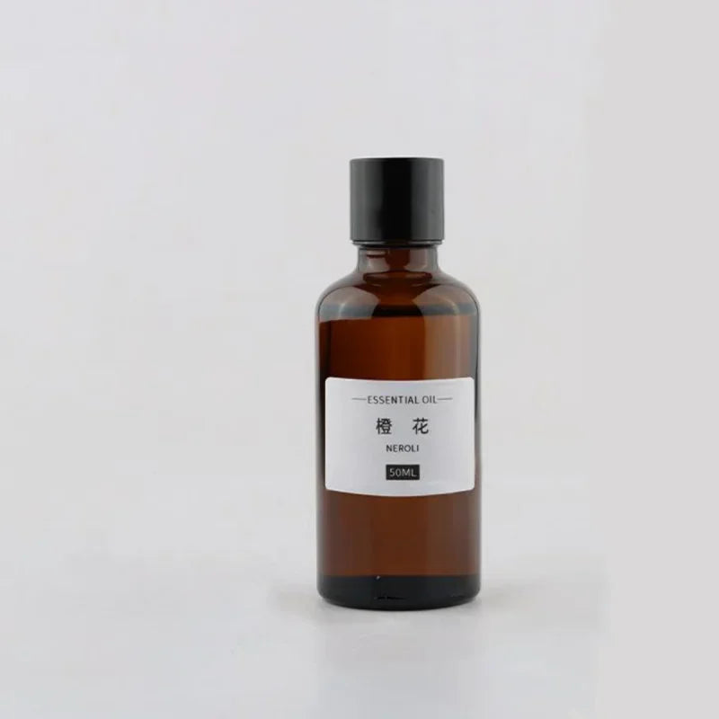50ml amber glass essential oil bottle with a black screw cap and a minimalist white Neroli label.