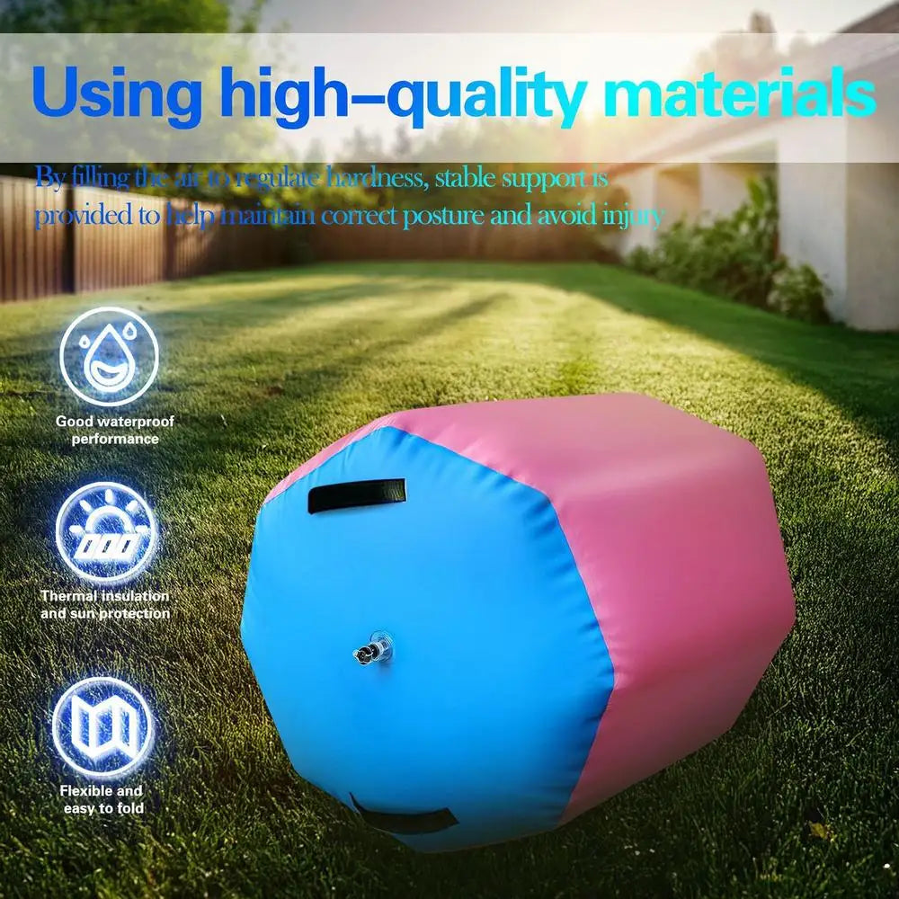 Pink and blue inflatable gymnastics air roller barrel with a central air valve, positioned on a grassy lawn.