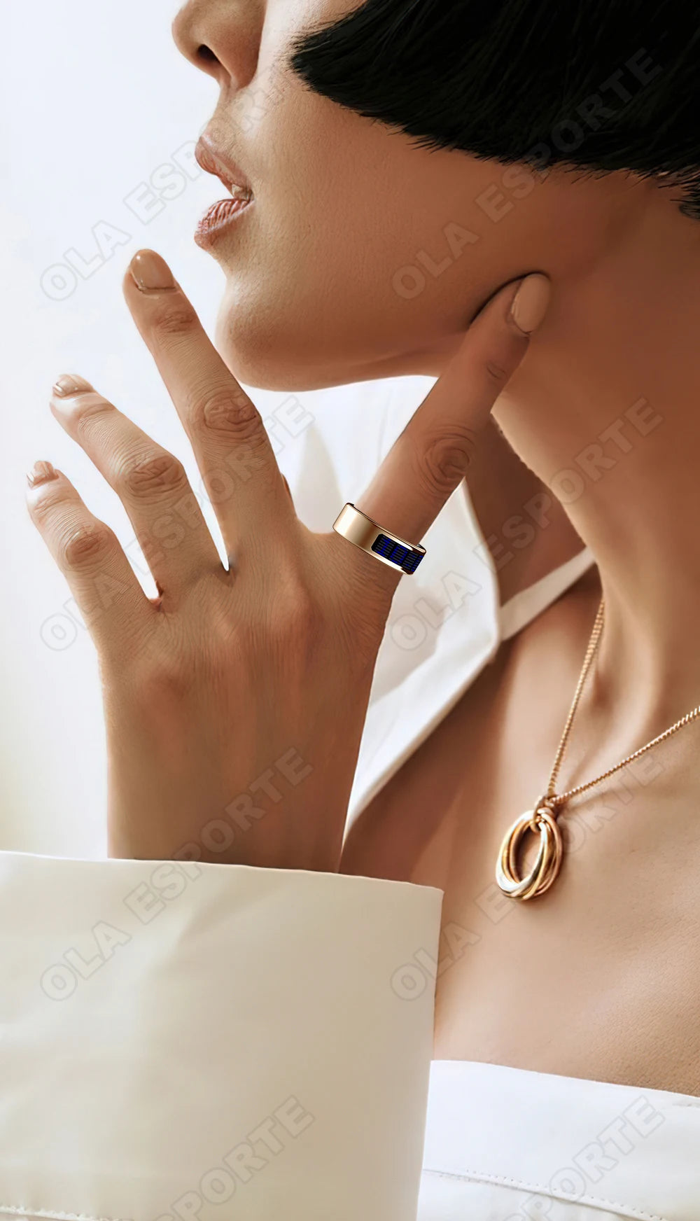 A sleek gold smart fitness tracking ring worn on a finger, featuring a slim, modern design with a dark display detail.