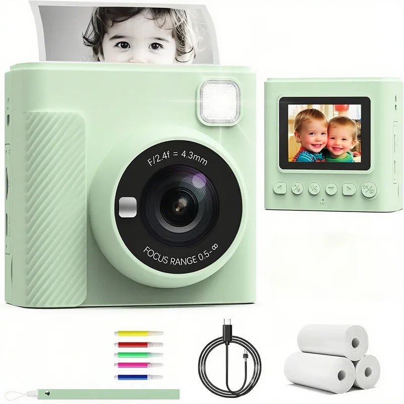 Mint green plastic kids' instant camera with screen, flash, USB-C cable, thermal paper rolls, and colored markers.