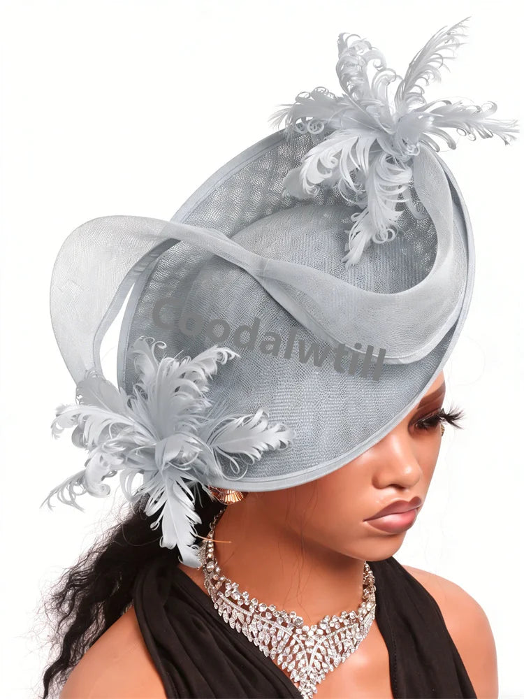 Elegant silver grey saucer fascinator with decorative feathers and sheer netting detail on a mannequin.