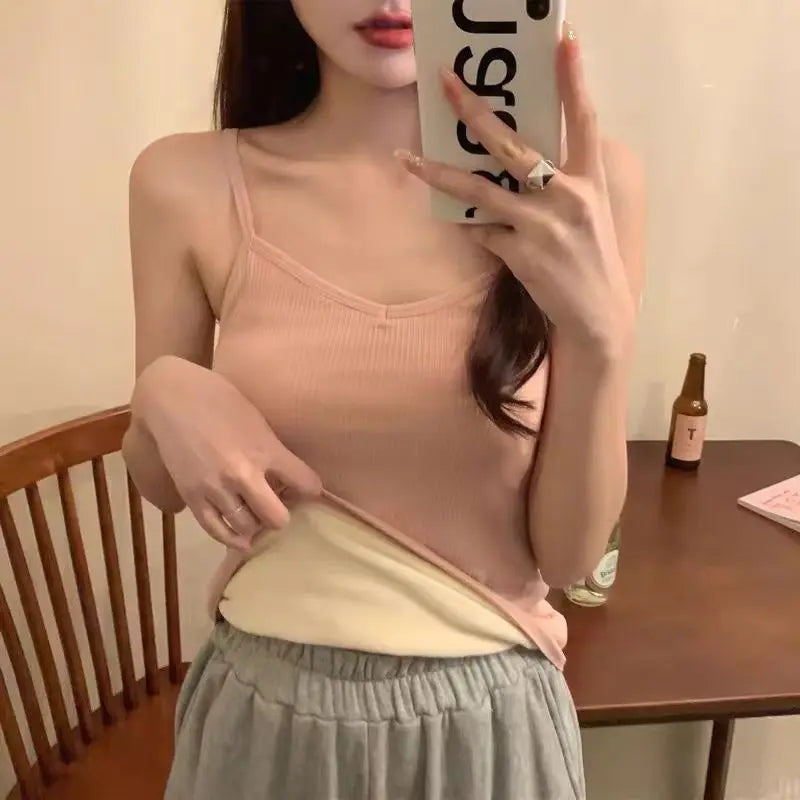 Soft pink ribbed camisole with a warm, cream-coloured fleece-lined interior, featuring thin straps and a V-neck.