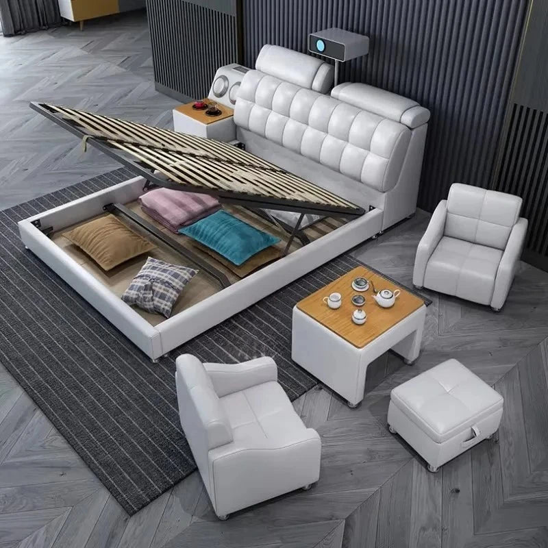 Modern white double storage bed with a tufted headboard, lift-up base, matching armchairs, and a small side table.