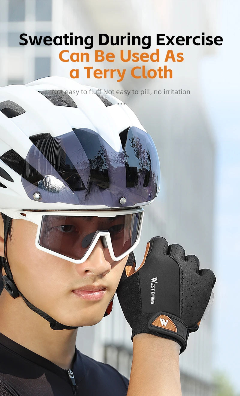 Cyclist wearing a white helmet, tinted visor, and black fingerless gloves with brown trim branding.