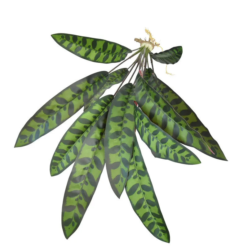 Artificial plant with long, lance-shaped leaves featuring a dark green, mottled, tiger-stripe pattern on a white base.