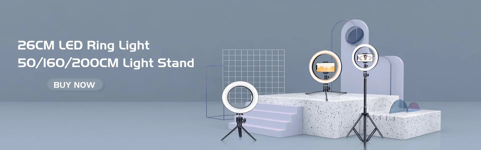 26cm black metal LED ring lights with adjustable tripod stands for smartphones, displayed on a studio platform.