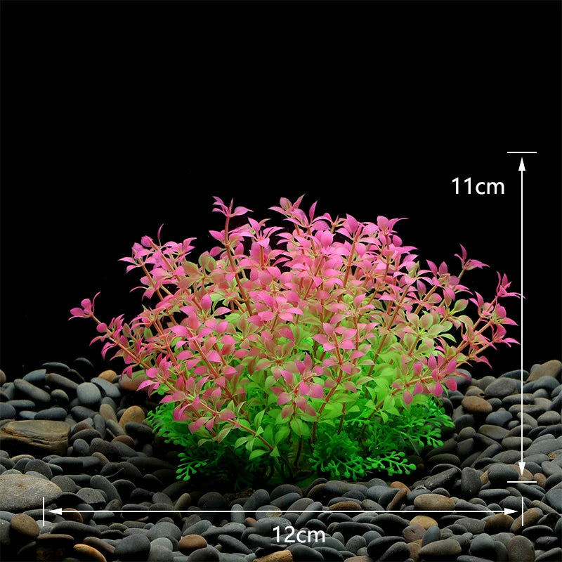 Artificial aquarium plant with pink-tipped leaves and a green base, set on black pebbles. Measures 12cm wide, 11cm high.
