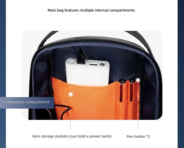 Interior of a black travel sling bag showing orange pockets for a power bank and two pen holders.