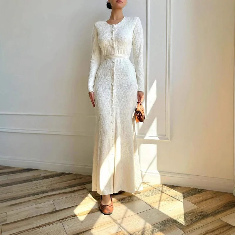Cream long-sleeved knit maxi dress with a chevron texture, button-front detail, and a slim fit.