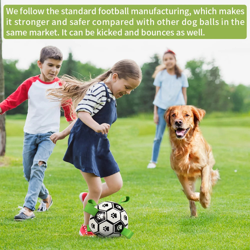 Black and white dog soccer ball with green grab straps, being played with by children and a golden retriever.