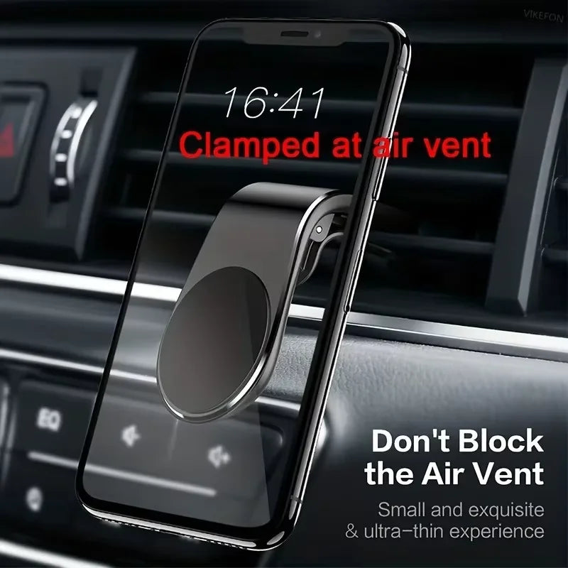A sleek, matte black magnetic smartphone mount attached to a car air vent, holding a smartphone.