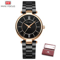 MINI FOCUS women's watch with round black face, rose gold case, roman numerals, and linked black strap.