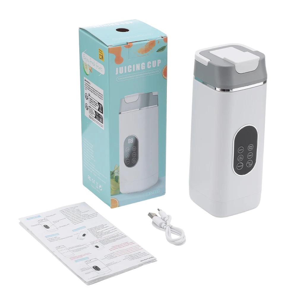 Portable white and grey electric blender with digital control panel, box packaging, USB cable, and manual.