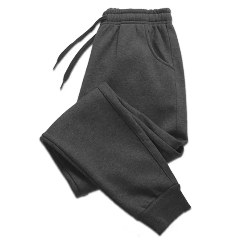 Dark charcoal grey fleece joggers with an elasticated drawstring waist, side pockets, and cuffed ankles.