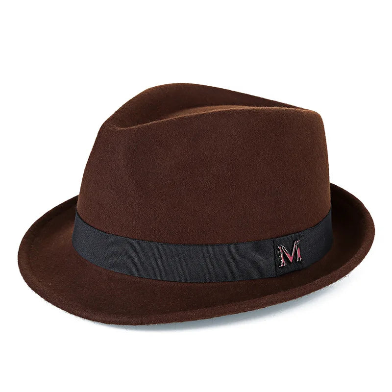 Classic dark brown wool felt fedora hat with a black ribbon band and metallic 'M' detail.