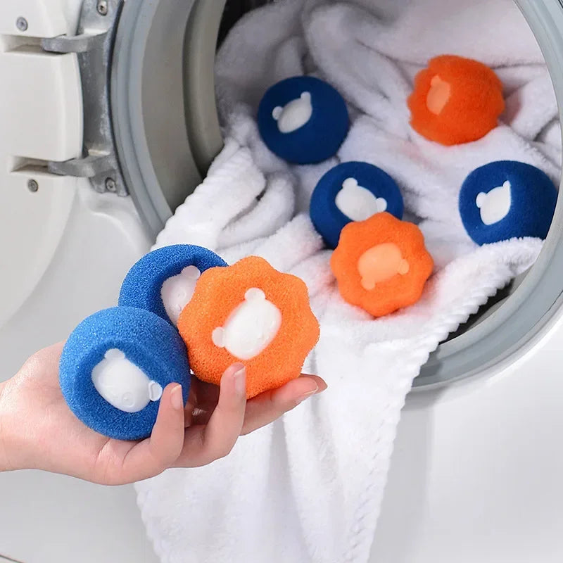 Hand holding blue and orange textured laundry washing balls with cute white bear-shaped centres.
