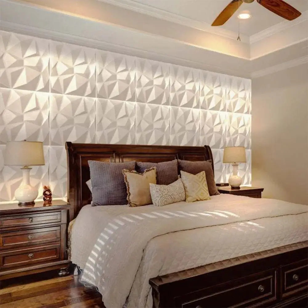 White 3D decorative wall tiles with a geometric diamond pattern installed as a feature wall behind a wooden bed.
