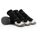 Black waterproof dog boots with grey anti-slip soles, reinforced toes, and adjustable reflective velcro straps.