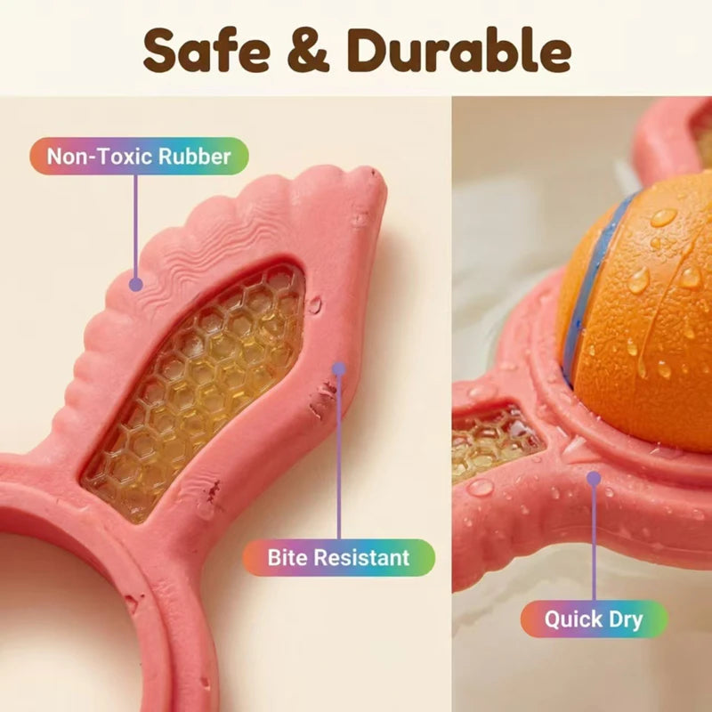 Pink, bite-resistant rubber dog ring with honeycomb detail and an orange ball, designed for water and dry play.