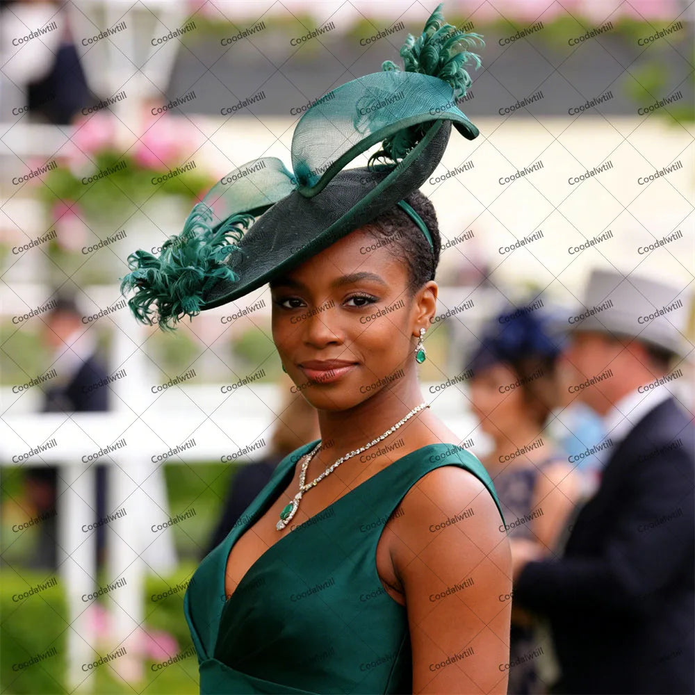Elegant dark green fascinator featuring structured mesh loops, delicate feathers and a slim headband.