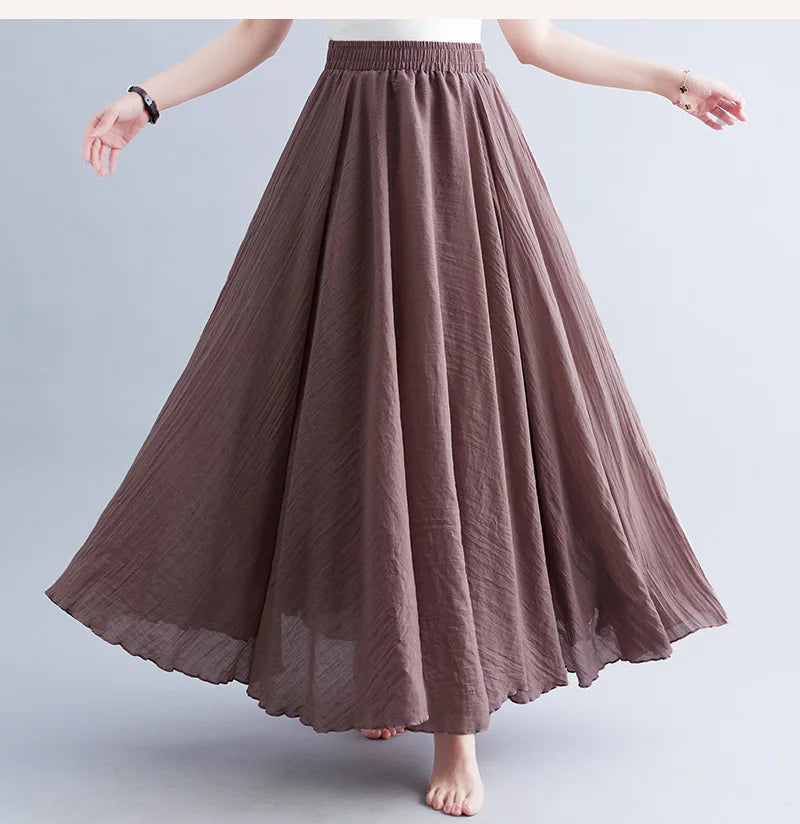Brown midi-length A-line skirt with an elasticated waistband and flowing, textured fabric.
