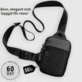 Small black anti-theft crossbody bag with an adjustable strap and a secure metal locking feature.