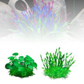 Three types of artificial aquarium plants, including one purple-tipped grass and two varieties of vibrant green plants.