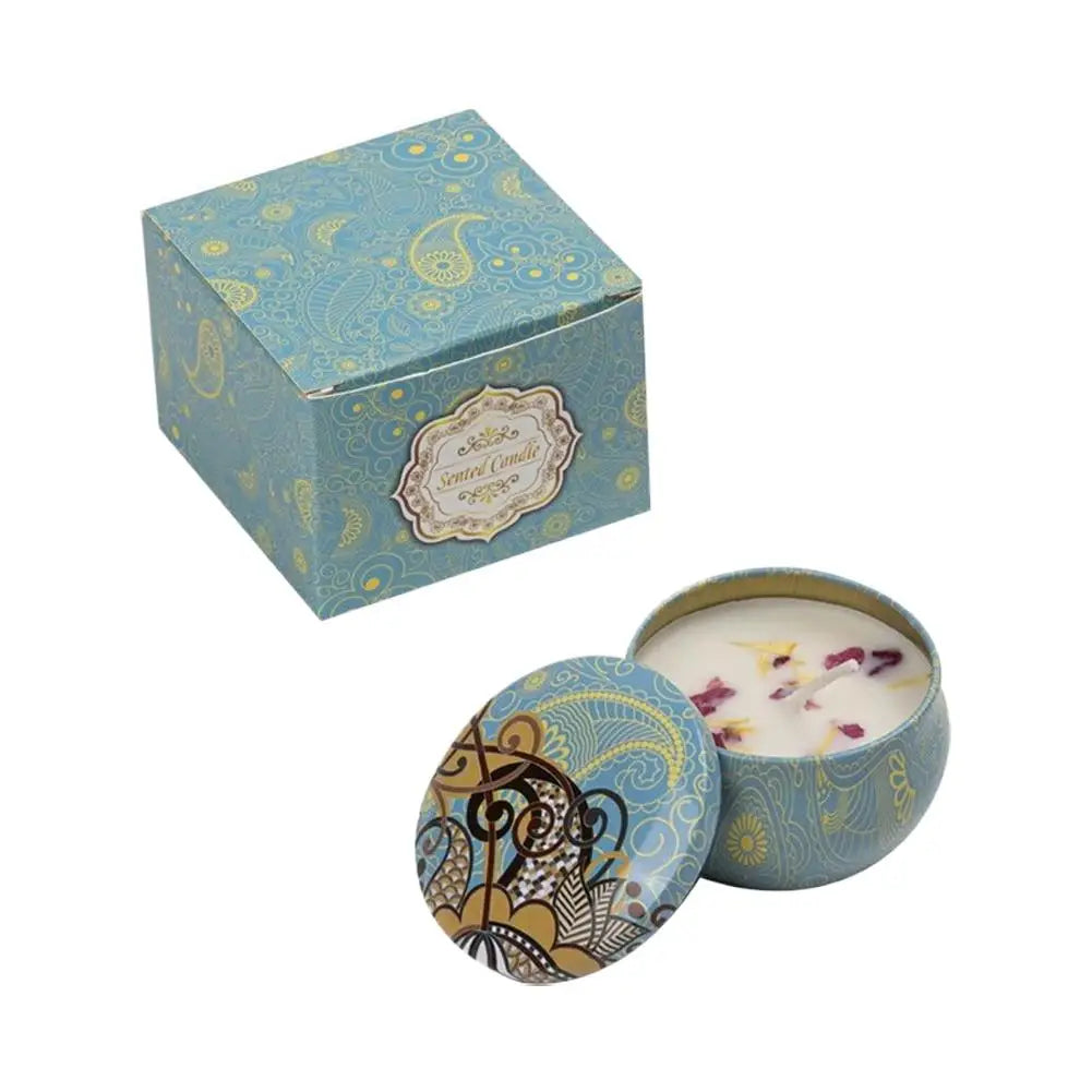 Scented candle in a blue patterned tin with a matching gift box, decorated with floral petals and intricate designs.