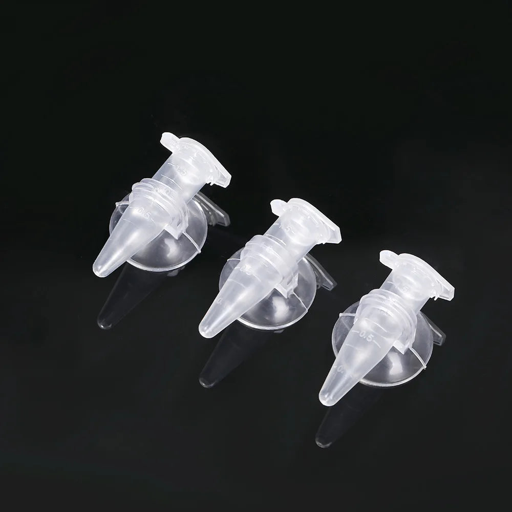Three clear, plastic conical pipette tips with measurement markings on black background.