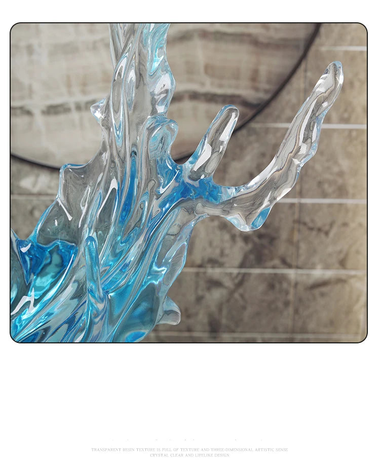 Abstract blue and clear resin ornament with a sculptural, wave-like aesthetic and glossy finish.