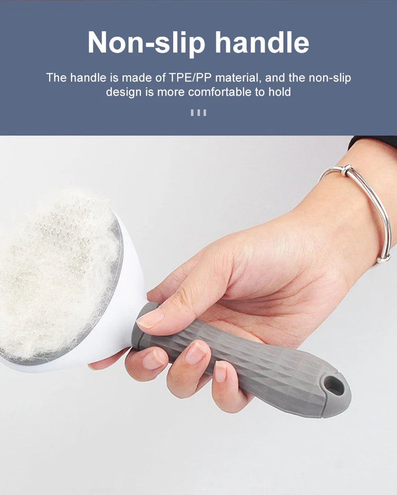 A person holding a pet grooming brush with a white head and a grey, diamond-patterned non-slip handle.