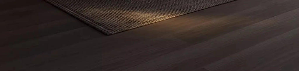 The image provided does not show a bed frame; it shows a textured rug on a dark wooden floor.