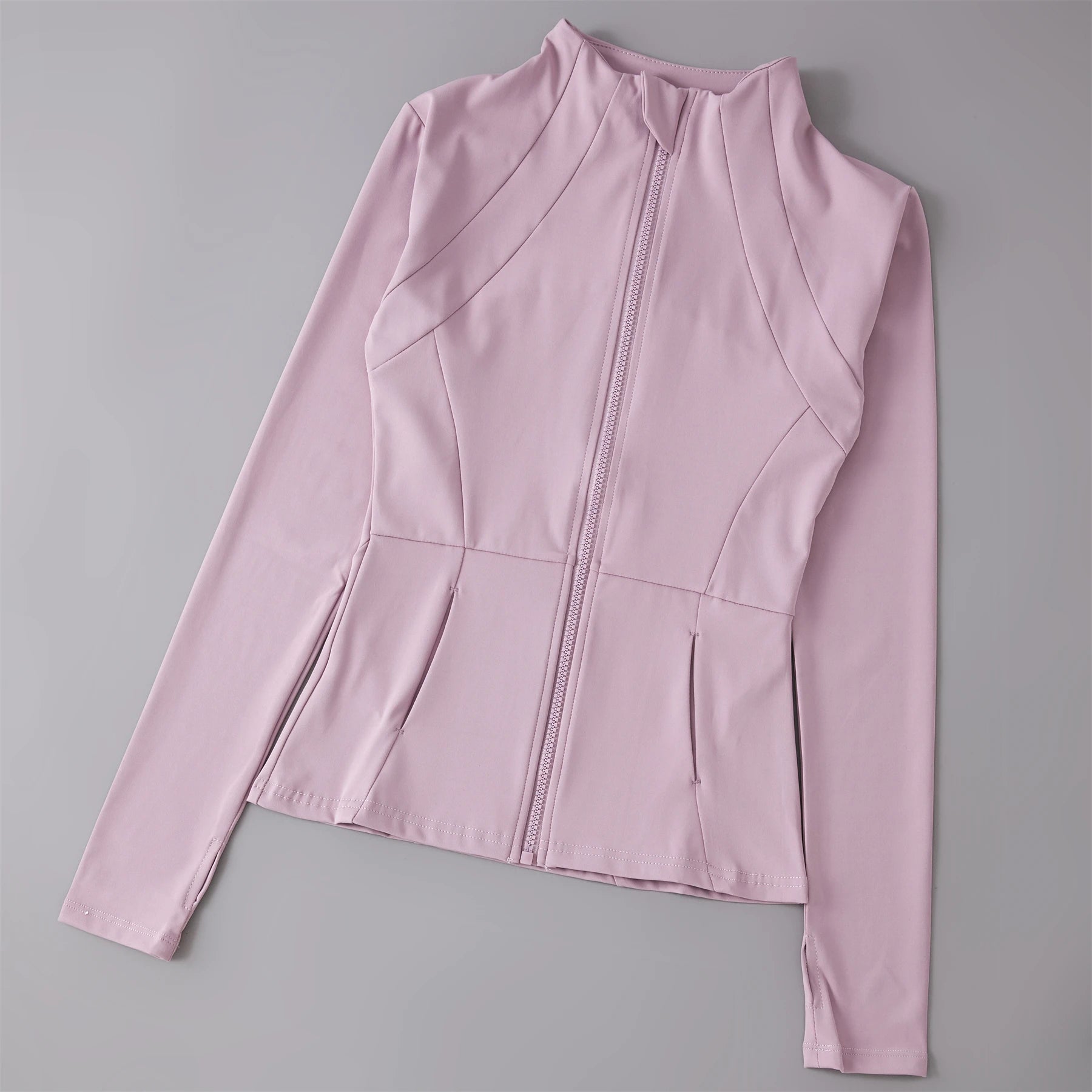 Dusty pink long-sleeve sports jacket with a high collar, full-length zip, and tailored seam detailing.