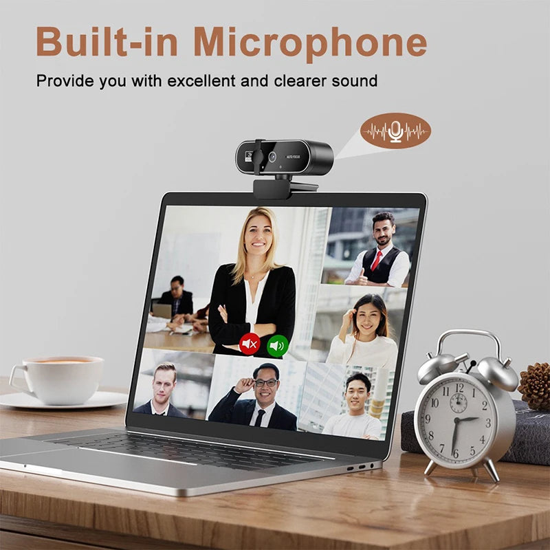 Black 4K autofocus webcam with built-in microphone mounted on a laptop showing a video call.